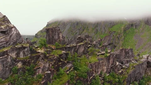 Aerial perspective of mossy mountain wall, stunning Lofoten islands' rocky Stock Footage 248705689