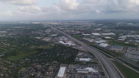An aerial perspective of a multi-lane highway stretching through a sprawling Video stock 337825315