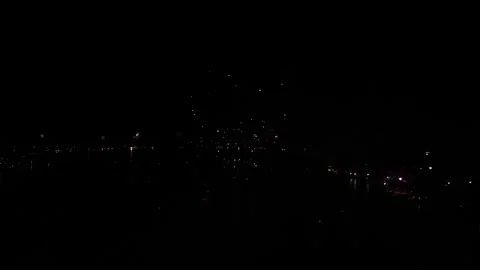 Aerial perspective of New Year fireworks bursting against a dark night sky Stock Footage 325949171