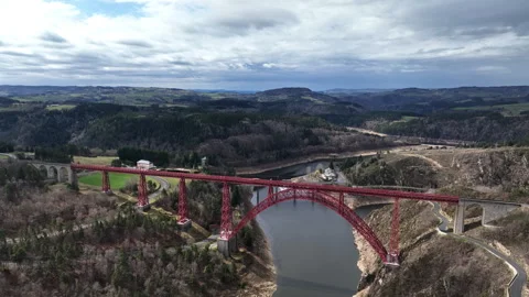 An aerial perspective reveals the structural elegance of the Garabit Viaduct. Stock Footage 250129899