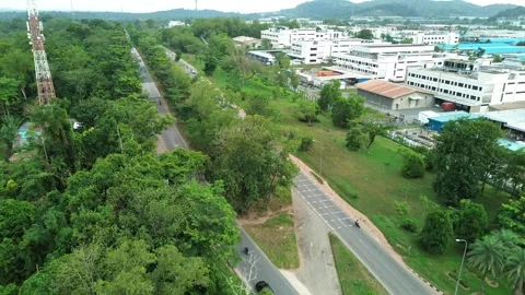 Aerial Perspective: Roads Weave Through Verdant Landscape and Urban Fringe Stock Footage 335126281