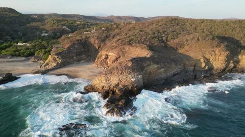 Aerial Perspective of Rolling Waves Breaking Along a Curved Coastline Mazunte Me Stock Footage 321707685