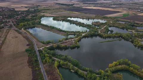 An aerial perspective showcases a cluster of interconnected lakes surrounded by Stockbeeldmateriaal 348229725