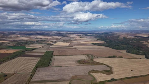 An aerial perspective showcases a vast patchwork of agricultural fields Stock Footage 347822131