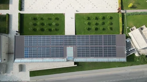 Aerial perspective shows solar panels covering a building roof Stock Footage 340240503