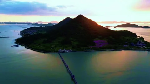 Aerial Perspective of Sinuous Purple Bridge Following Island Coastline Stock Footage 328241511