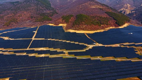 Aerial perspective of solar array panels on hilly ground Stock Footage 330070372