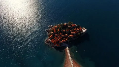 Aerial perspective of a tiny island surrounded by liquid expanse Stock Footage 268686208