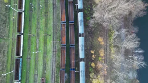 Aerial perspective of a train yard, highlighting various freight cars and Видео 347791418