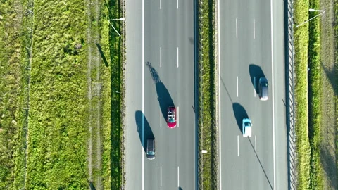 Aerial perspective of two parallel highway sections with cars moving in Stock Footage 321521320