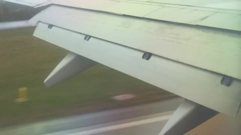 From an aerial perspective, we see an airplane wing gracefully soaring high Stock-Footage 296794036