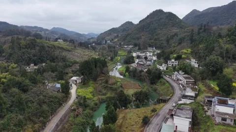 Aerial Perspective of a Winding Road through a Modern Chinese Village 動画素材 332315686