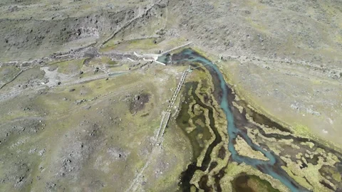 Aerial photo of algae covered stream in rugged remote terrain Stock Footage 283415521