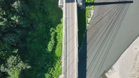 Aerial photography of a cable-stayed bridge in a mountain gorge with a green Vidéo 145575401