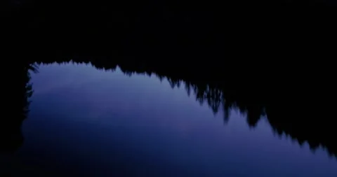 Aerial: Pine trees reflected in a lake at sunset. Marina, California, USA Stock Footage 265197415