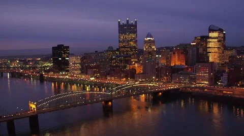 Aerial of Pittsburgh at night flying over the Mon River toward the city Stock Footage 59377692