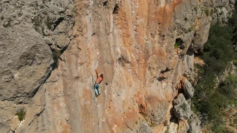 Aerial point of view from drone of strong muscular man climbs on big rock tufa Stock Footage 154153247
