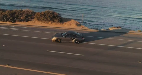 Aerial of Porsche 911 Turbo S driving on southern California road at Stock Footage