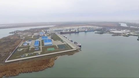 Aerial port crane bridge and bulk carrier. Close up view Cargo freight ship and Stock Footage
