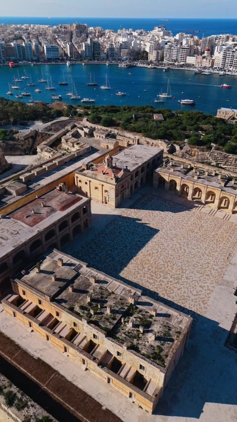 Aerial portrait high angle panning drone shot over fort manoel malta at summer Stock Footage 335352884