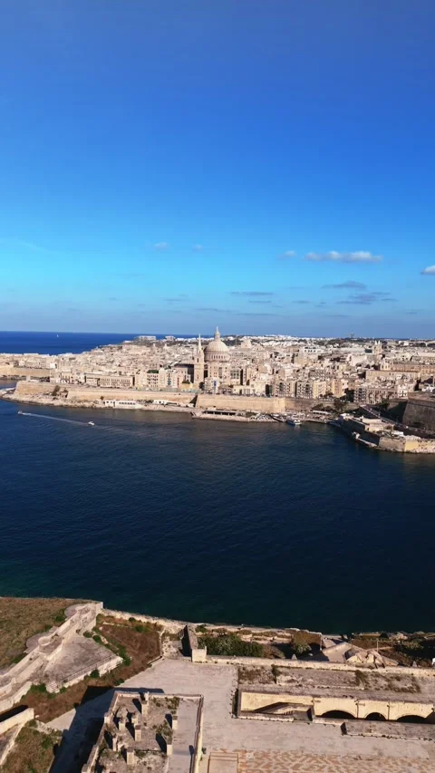 Aerial portrait wide angle static drone shot of valletta Malta with summer blue Stock Footage 335295853