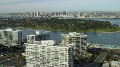 Aerial, pov, waters of San Diego Bay with the downtown skyline in the distance Stock Footage