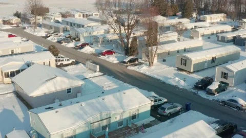 Aerial of prefabricated mobile home, trailer park covered in winter snow Stock Footage