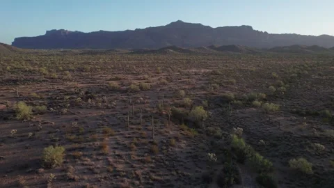 Aerial of a pristine desert landscape with iconic mountains in the background Stock Footage 335550334