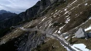 Aerial - Pro Cyclist Going Down The Road In The Mountains On A Sunny Day Stock Footage