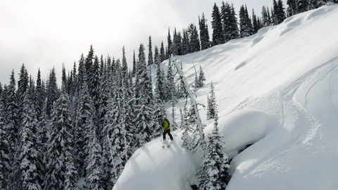 Aerial of pro skier jumping down from hill and crashing into snow in Montana Stock Footage 124210538
