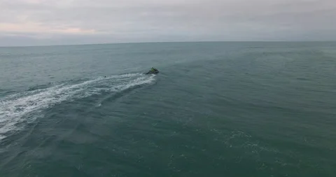 Aerial of pro surfer using jet ski to travel across broad atlantic ocean Stock Footage 158628481
