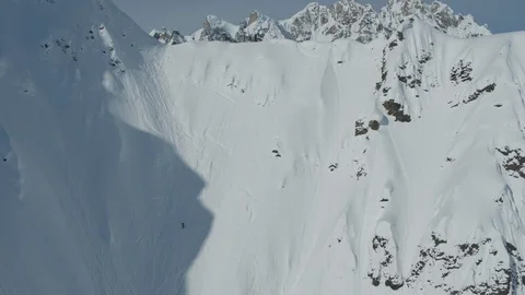 Aerial of professional skier going down steep hill from mountain Denali Stock Footage 121594784