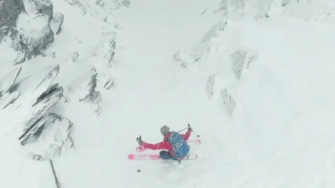 Aerial of professional skier going down snow covered mountain skillfully in Alps Stock Footage 121595569