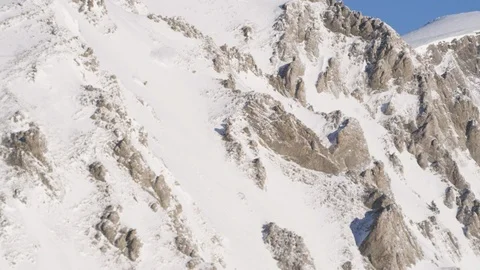 Aerial of professional skier speeding down steep mountain face Stock Footage 113221541