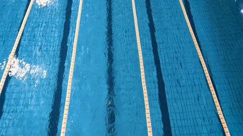 AERIAL: professional swimmer finishes at a distance. 4K. View from above. Stock Footage