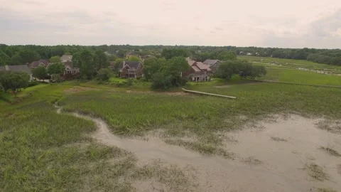 Aerial of property by a marsh Stock Footage 167372115