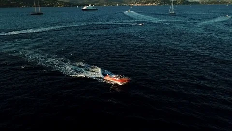 Aerial pull away of Luxury Classic Riva in the Bay of St Tropez Stock Footage