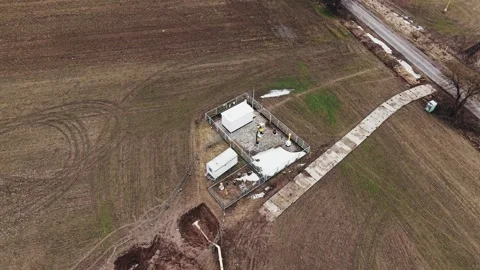 Aerial pull-away shot of natural gas pipeline station in Poland during winter Stock Footage 335047583