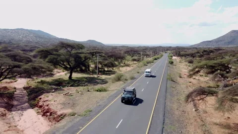 Aerial pull away shot of vehicles driving in Ethiopia Stock Footage 221522842