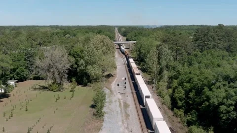 Aerial pull away view of a freight train moving Georgia, USA. Stock Footage 339912262