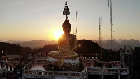 Aerial Pull Away View of Tiger Cave Temple Buddha Glowing in Sunset Stock Footage 142300495