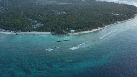 Aerial Pull Away of Waves Over Gili Trawangan Island, Indonesia Stock Footage 125846151