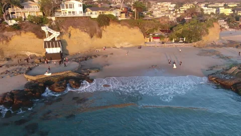 Aerial Pull Away of Waves Over Laguna Beach Stock Footage 157188527