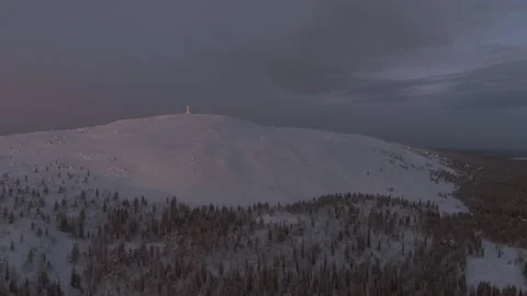 Aerial pull back away from the Luosto fell over frozen trees of Finland, polar Stock Footage 346647951