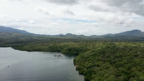 Aerial pull-back of bay, tropical forest and beach resort, 4k Video stock 122616539