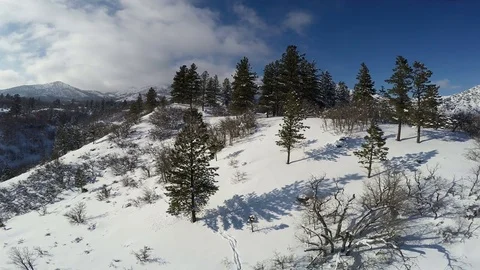Aerial-Pull back from beautiful snowy mountain scene Stock Footage 71965988