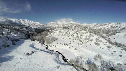 Aerial-Pull back from beautiful snowy mountain scene Stock Footage 72167187