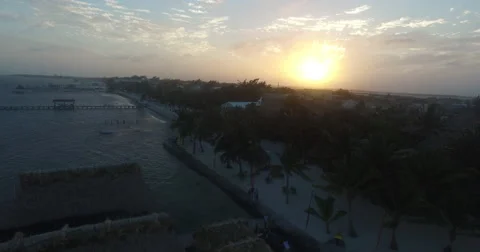 Aerial pull back on Belize coast while the sun sets Stock-Footage 66256338
