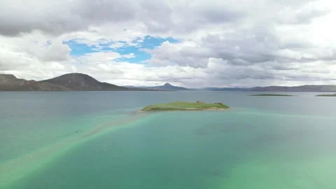 Aerial Pull Back of Bird Island and Turquoise Waters in Tso Ngön Lake, Tibet Stock Footage 326212663