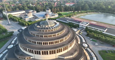 Aerial pull back from Centennial Hall in Wrocław at golden hour Видео 346659075